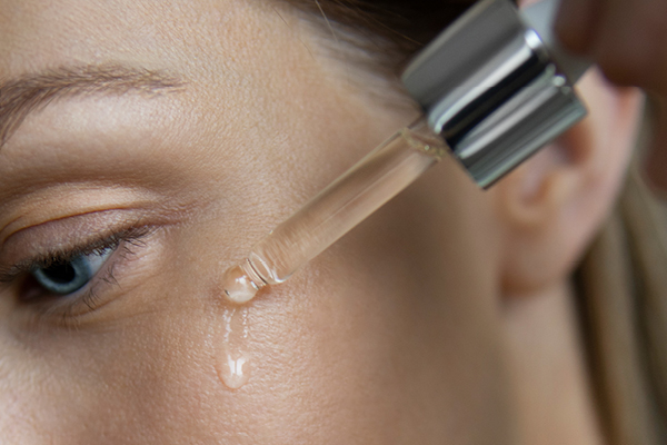 Kvinna som applicera serum innehållande retinol